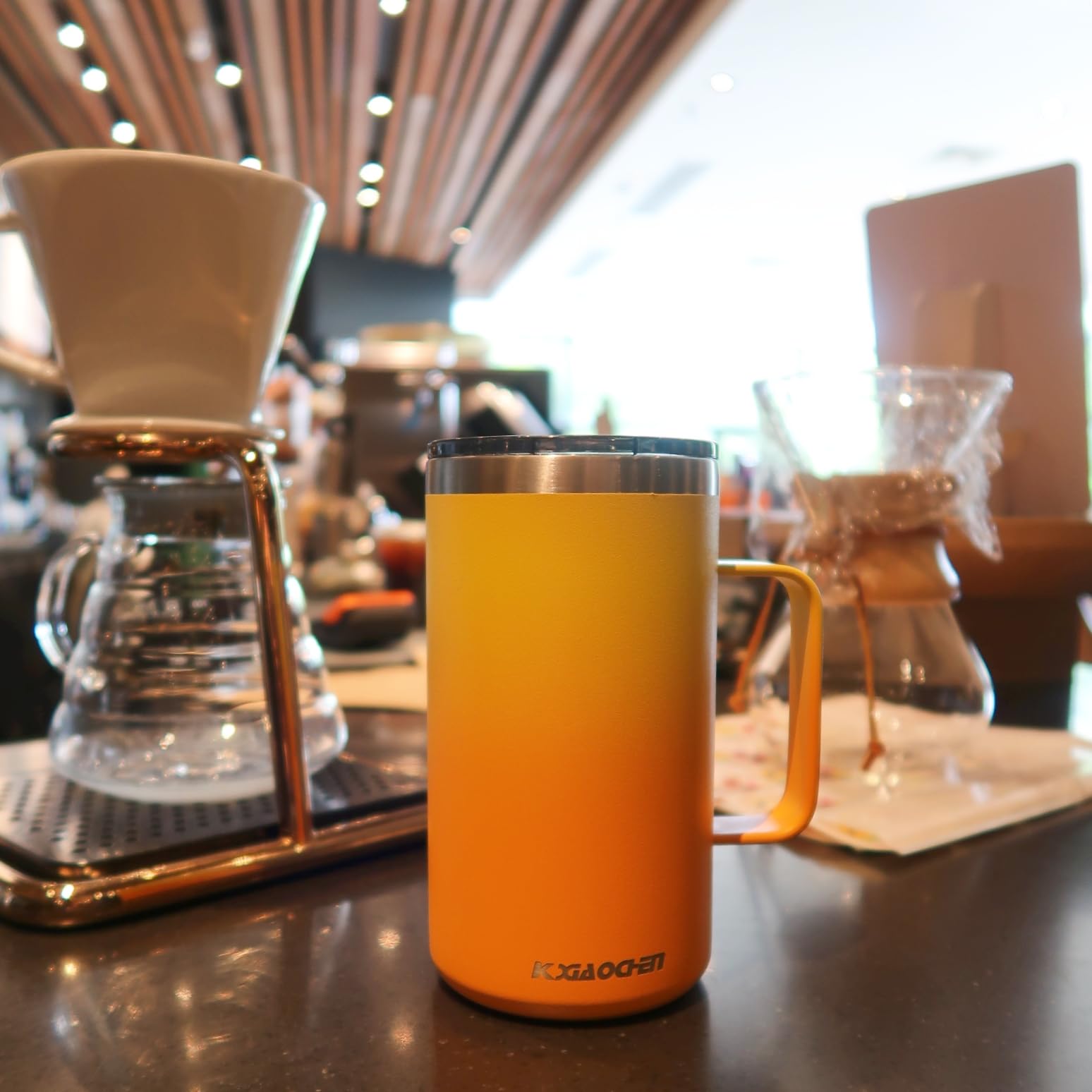 KXIAOCHEN travel mug in outdoor setting ready for a commute or hike.