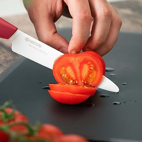 KYOCERA 6-inch chef knife with red handle delivers precise vegetable slicing.