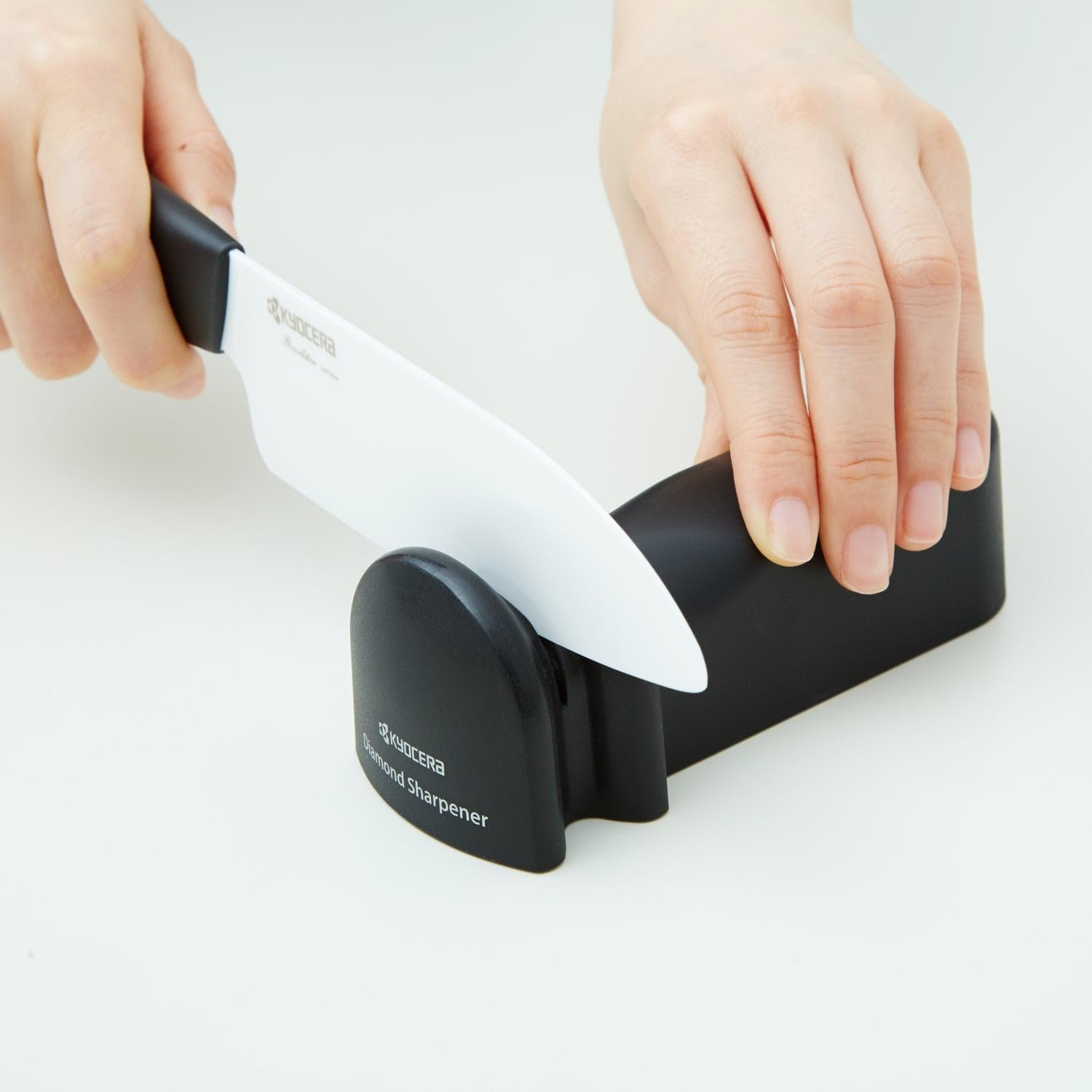 KYOCERA Advanced Ceramics sharpener in use demonstrates controlled back and forth sharpening