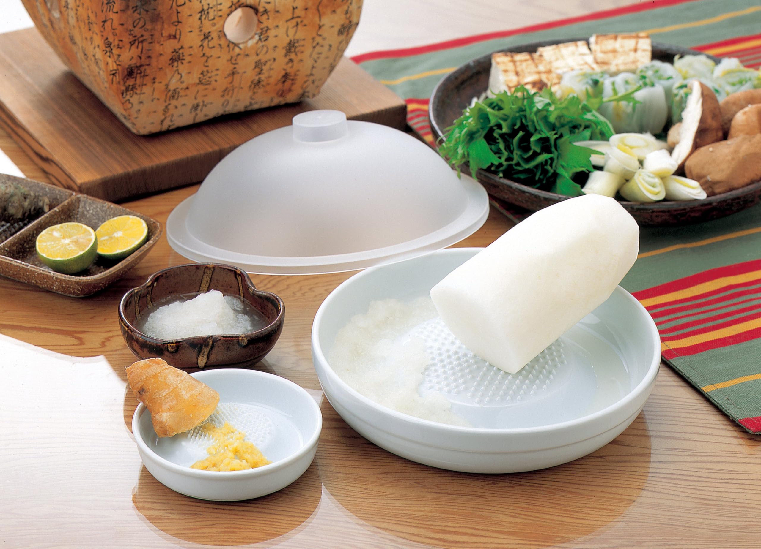 KYOCERA grater with collected ginger juice in a non-reactive bowl.