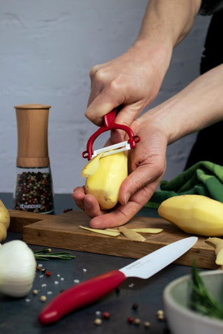 Kyocera paring knife peeling small fruits with gentle, controlled motions.