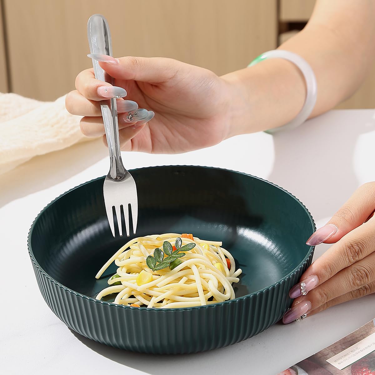 Kyraton dark green bowls in kitchen; modern look complements casual dinners.