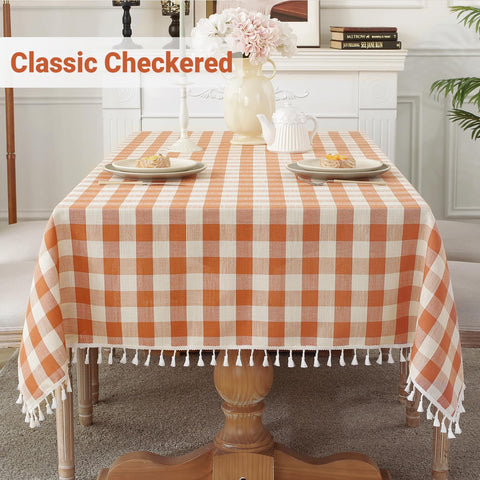 Laolitou buffalo plaid orange tablecloth adds bright warmth to any rectangle dining space.