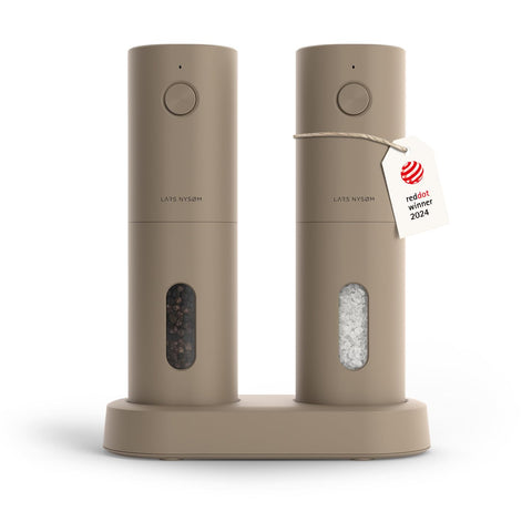 LARS NYSØM Spaending electric salt and pepper mills on a kitchen counter for easy seasoning.