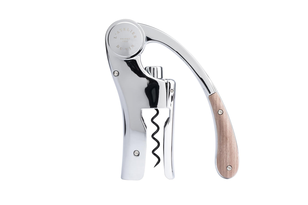 L'Atelier du Vin Oeno Motion lever corkscrew in action for smooth uncorking at tastings.