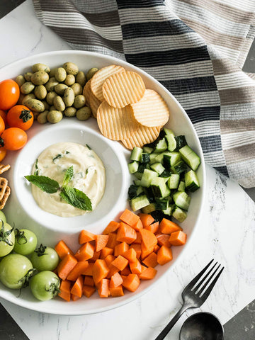 Lauchuh porcelain dip platter ready for cheese and crackers on a table.