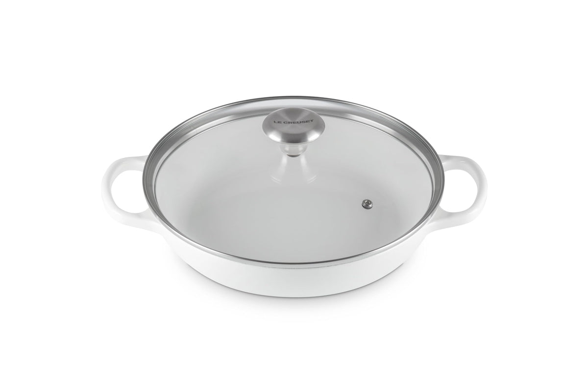 Le Creuset round braiser in enameled iron finish, even heat distribution.