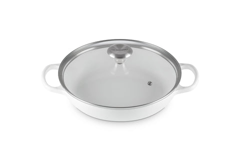 Le Creuset round braiser in enameled iron finish, even heat distribution.