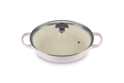 Le Creuset Signature round braiser in Shallot with lid on for even heat distribution.