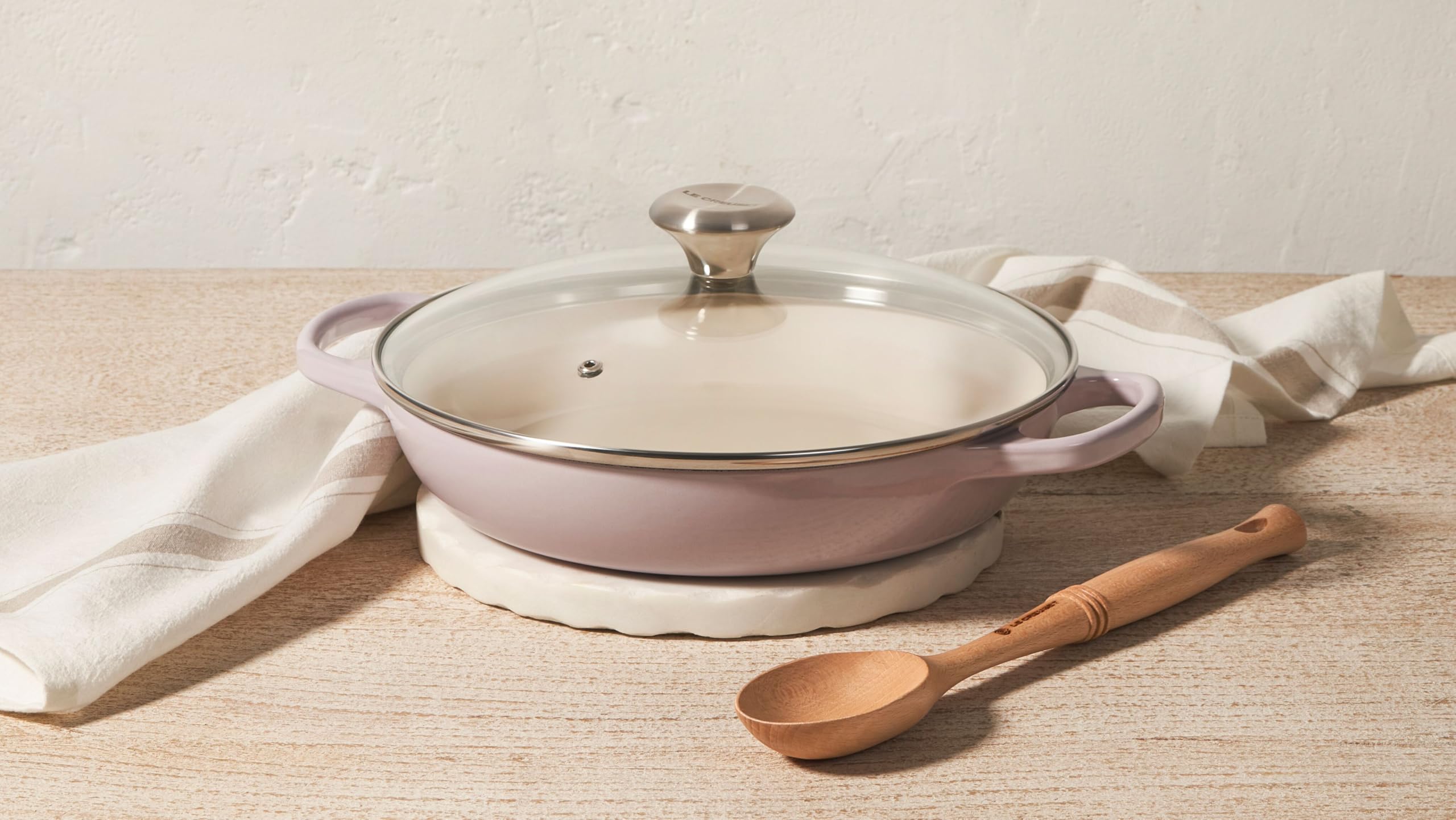 Le Creuset serving-ready braiser elevates table presentation.