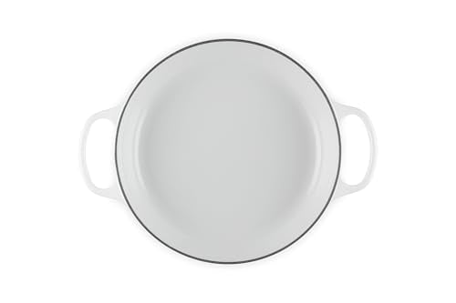 Le Creuset braiser interior with white enamel for easy monitoring.