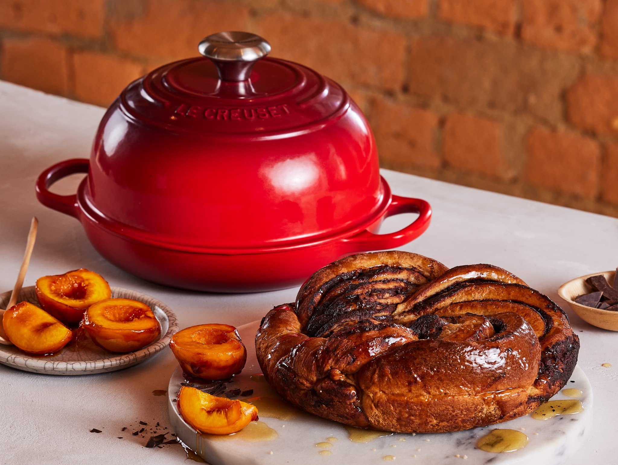 Le Creuset Bread Oven Cerise steam trap enhances aroma and rise.
