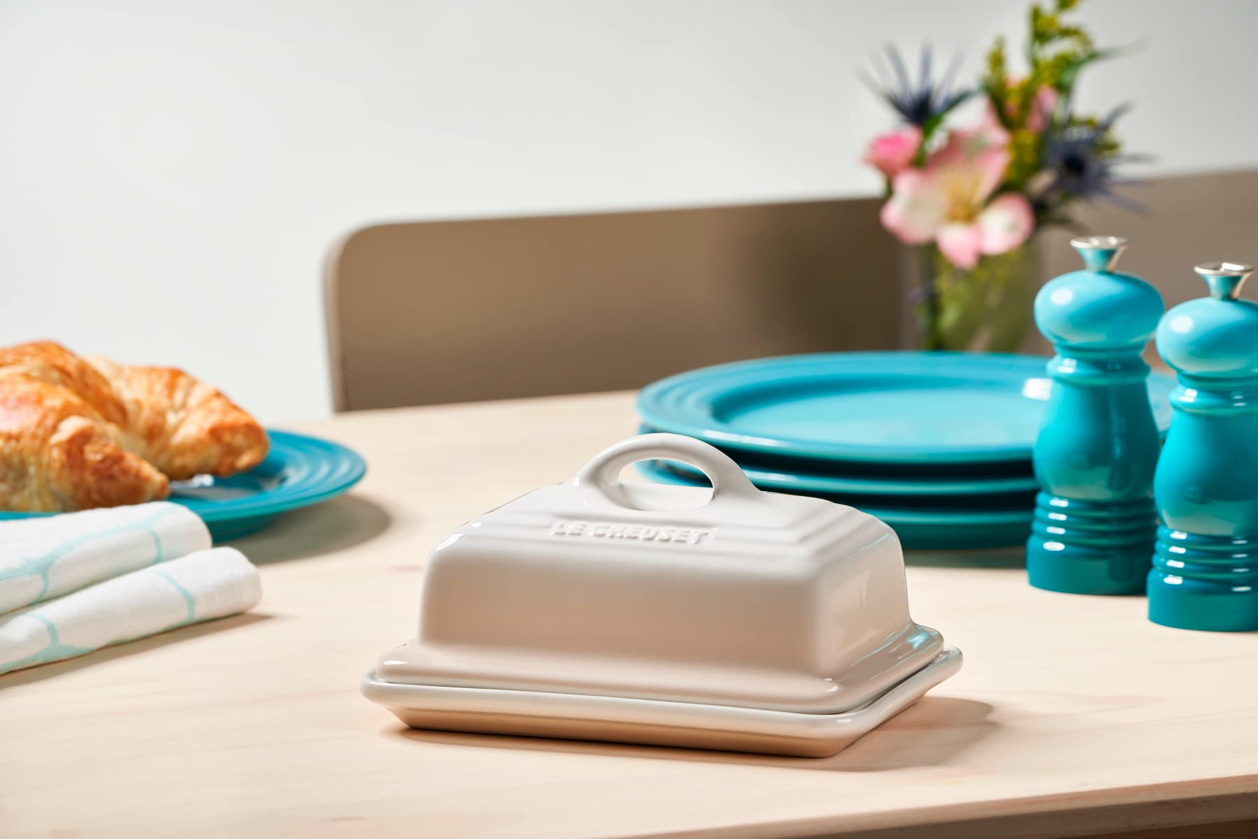 Le Creuset butter dish on table ready for serving and cleanup.