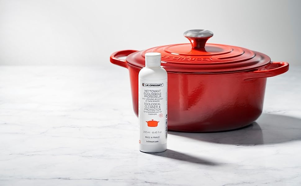 Le Creuset cleaner being applied to enamel surface to lift stains