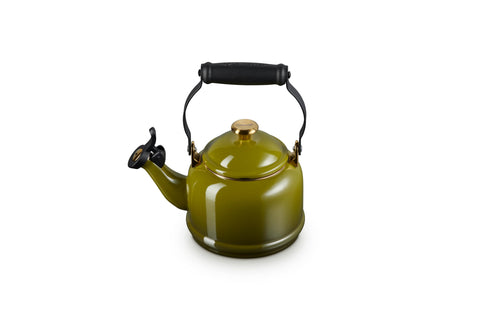 Le Creuset Demi Tea Kettle in olive with gold finish on stove heats water quickly for tea