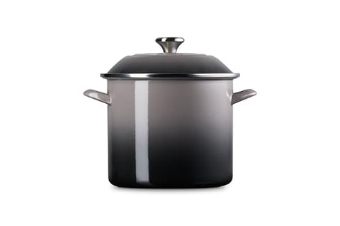Le Creuset oyster knob highlights cool-touch safety during lid handling.