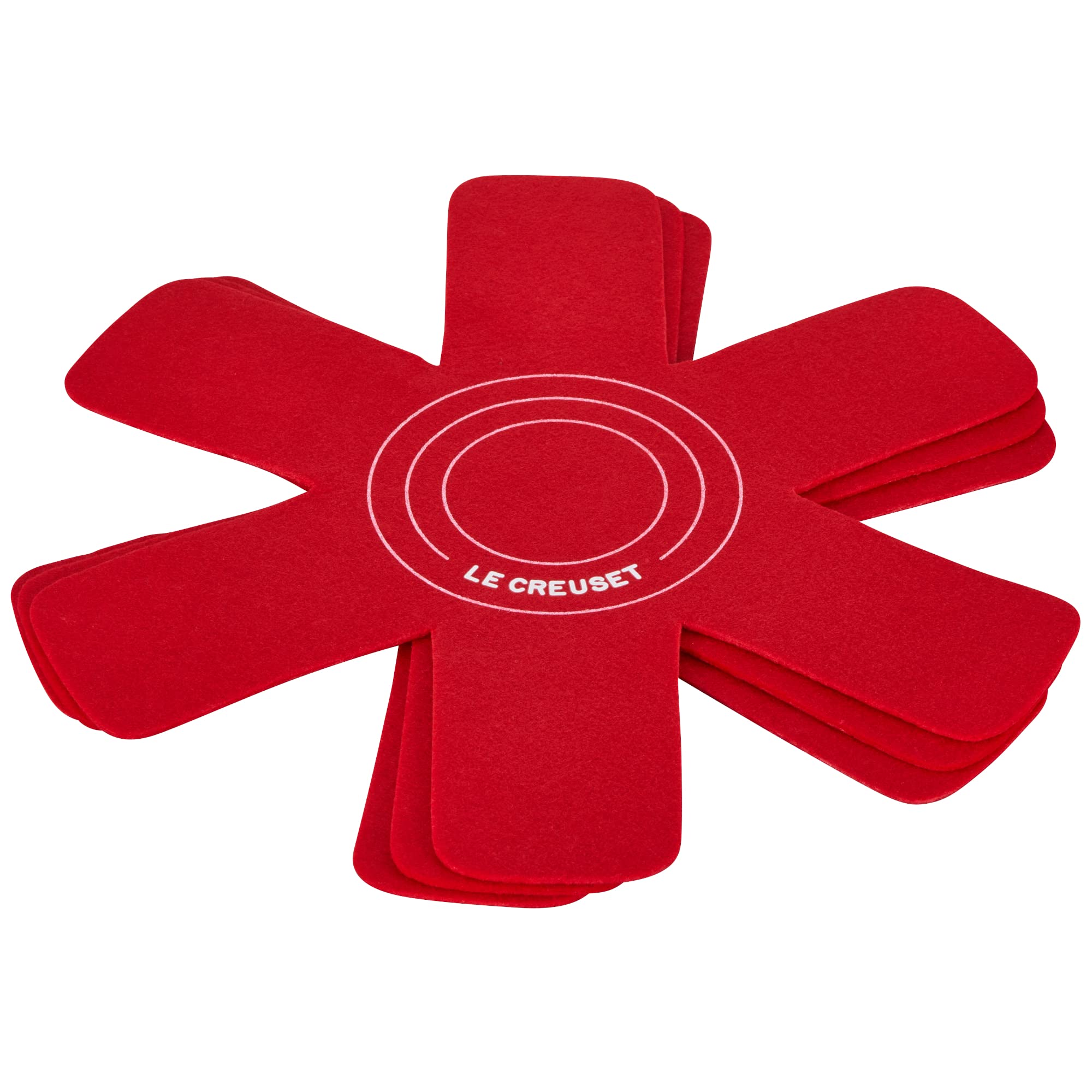 Le Creuset felt protectors for nested pots, visible cushioning between cookware.