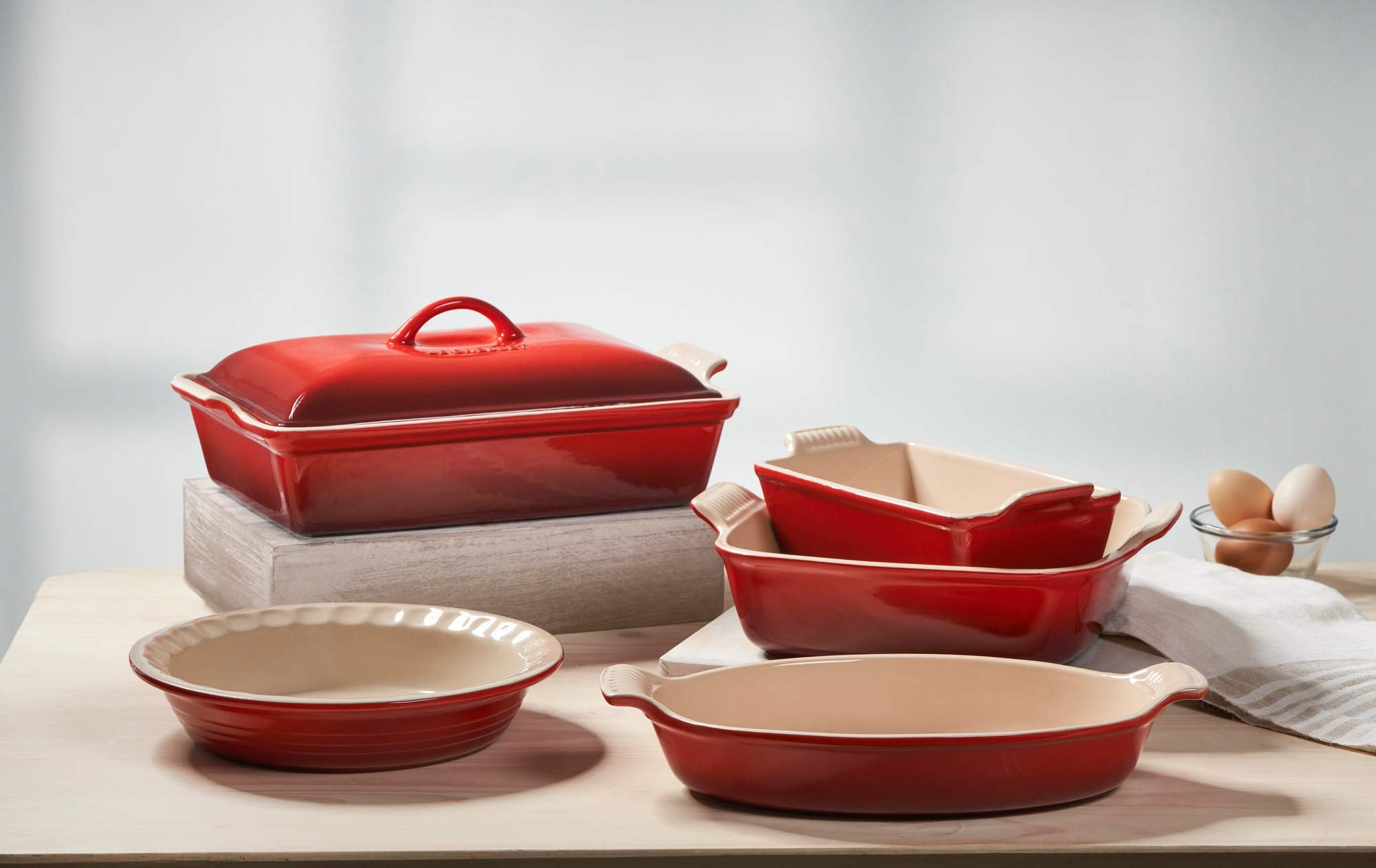 Le Creuset Heritage Oval Au Gratin Dish Cerise, side-handles visible for easy grip and serving.