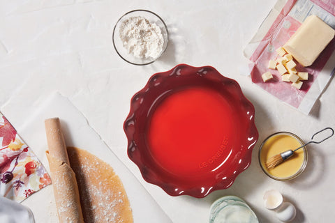 Le Creuset Cerise pie dish in the oven demonstrates heat retention for warm servings.
