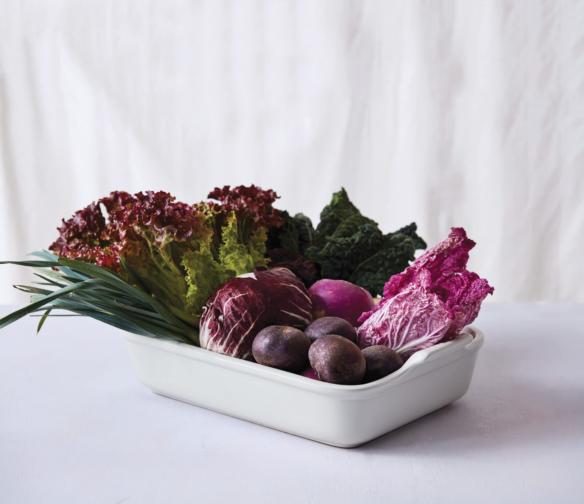 Le Creuset Heritage set on counter demonstrates ready-to-use versatility.
