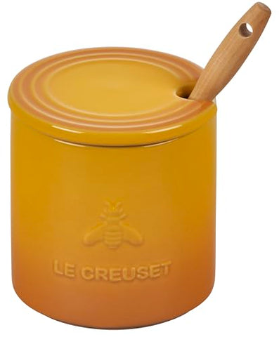 Le Creuset Nectar honey pot on the countertop showing vibrant glaze.