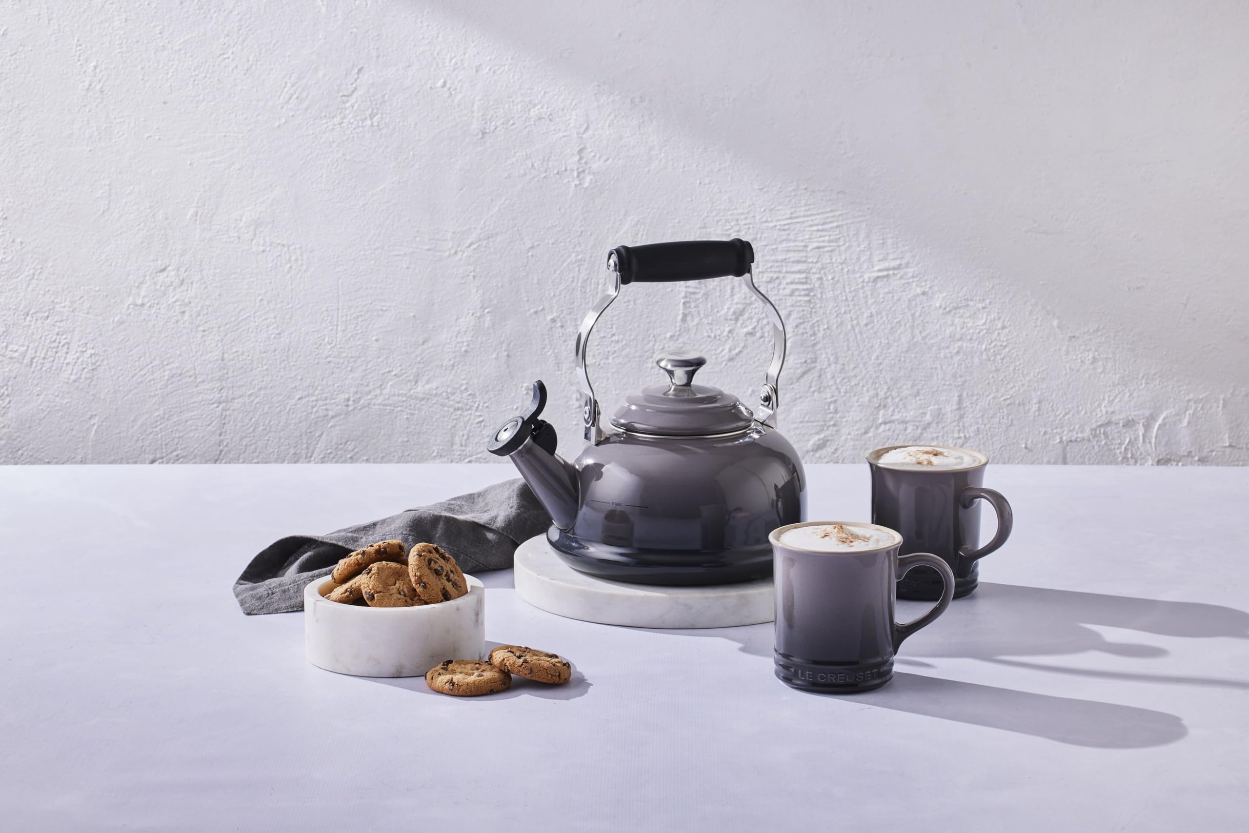 Le Creuset whistle emits a clear boil cue for safe pouring.