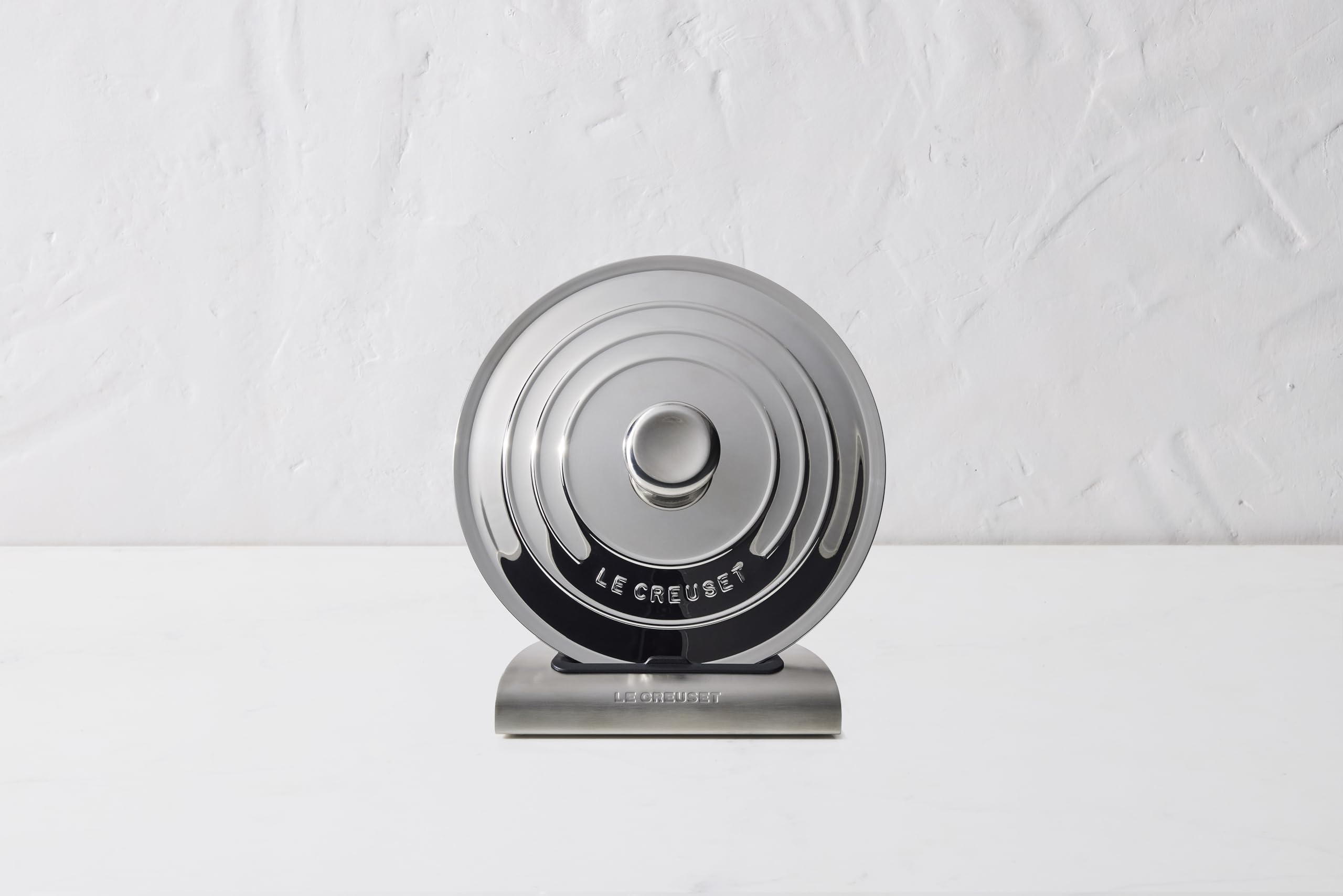 Le Creuset lid holder folds flat for compact storage in cupboard