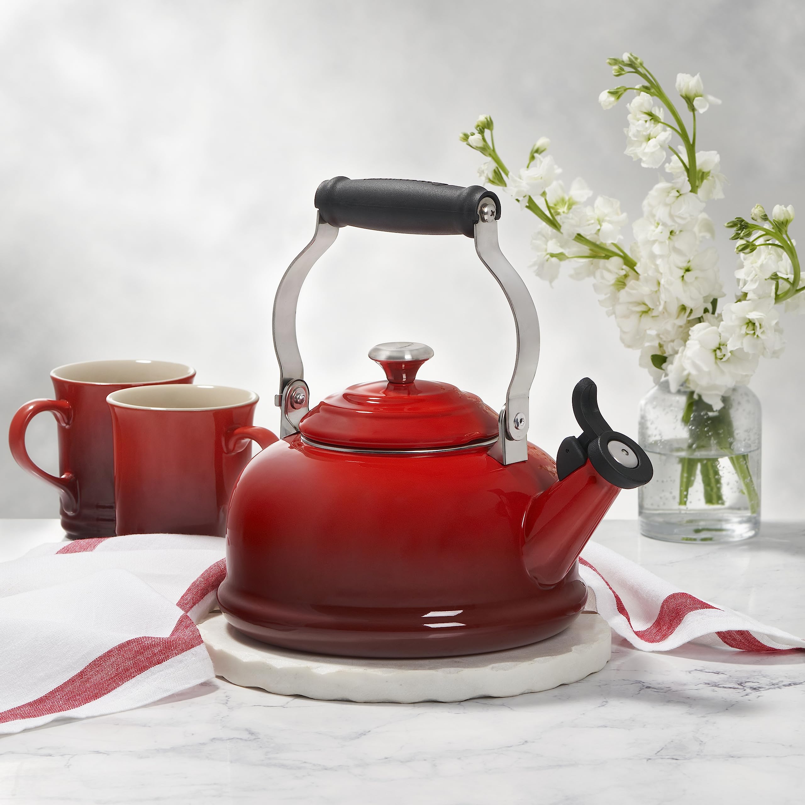 Le Creuset Marseille enamel kettle full view showcasing compact shape and vibrant color.