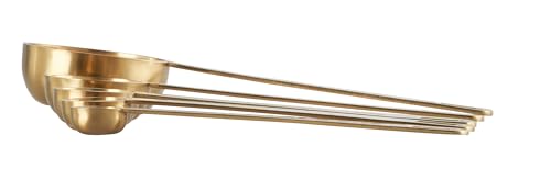 Le Creuset gold measuring spoons show 1-4-tsp scale for consistent portions.
