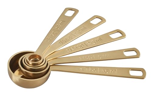 Le Creuset gold measuring spoons 1-tsp for seasoning liquids and powders.