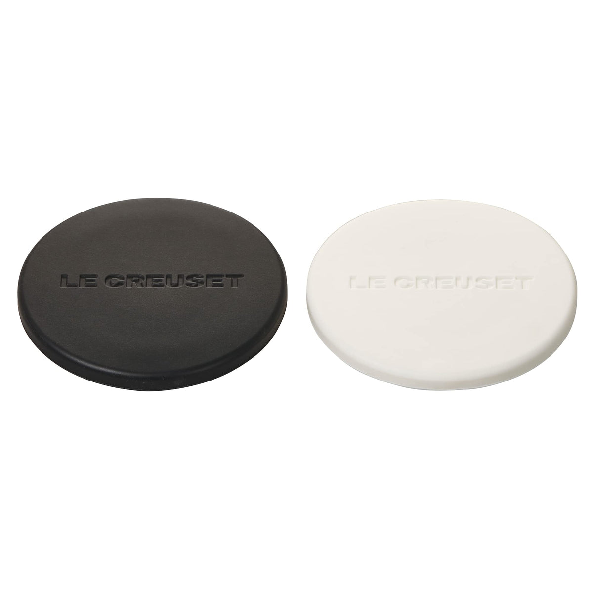Le Creuset mill caps in black and white catch salt and pepper residue to protect countertops.