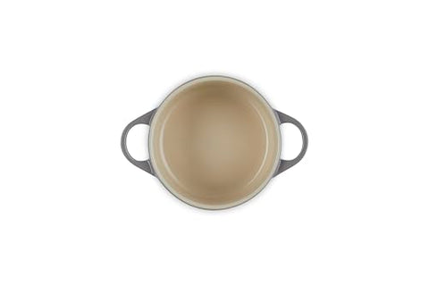 Le Creuset oyster cocotte interior enamel resists sticking and cleans easily.