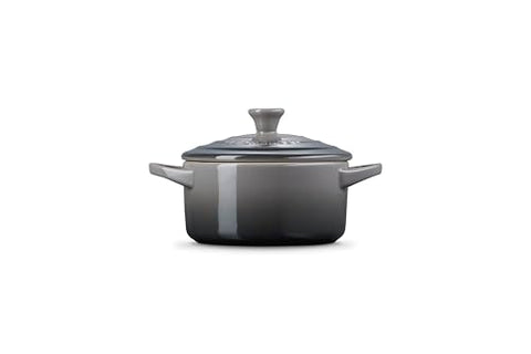 Le Creuset cocotte with loop handles provides secure grip during transport.
