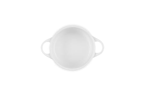 Le Creuset mini round cocotte white, lid knob close-up shows heat-and-moisture seal.