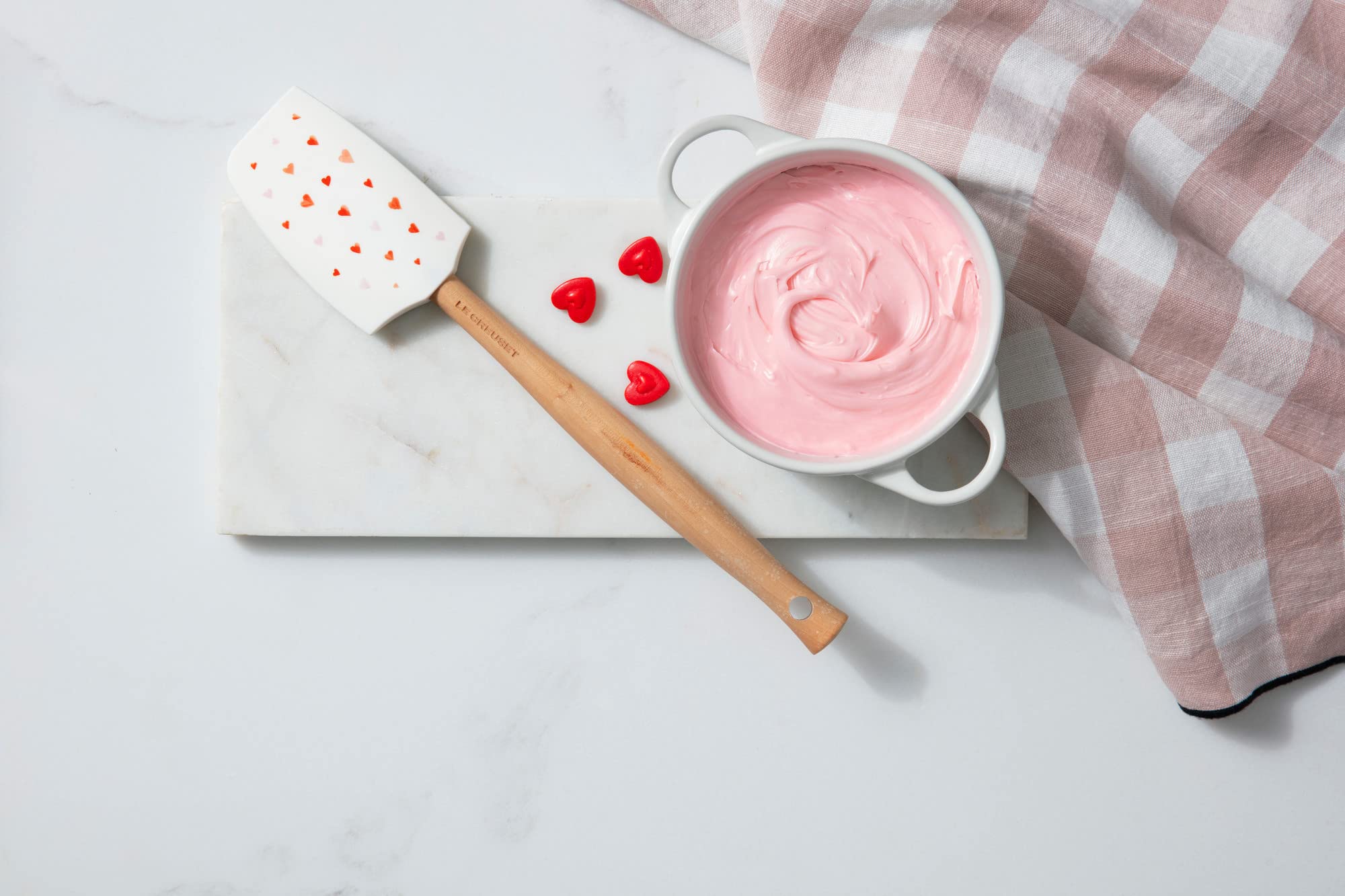Le Creuset mini round cocotte white on table, elegant single-serving presentation.