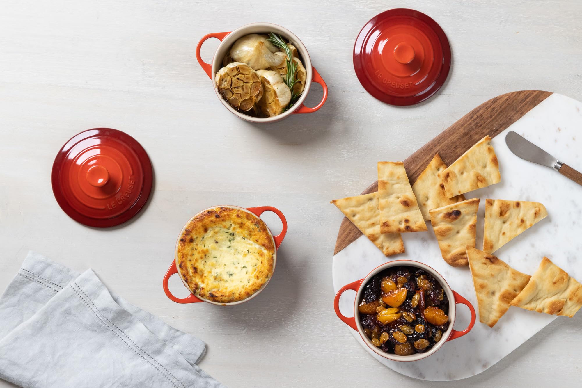 Le Creuset mini round cocotte cerise, freezer to oven readiness for meal prep flexibility.