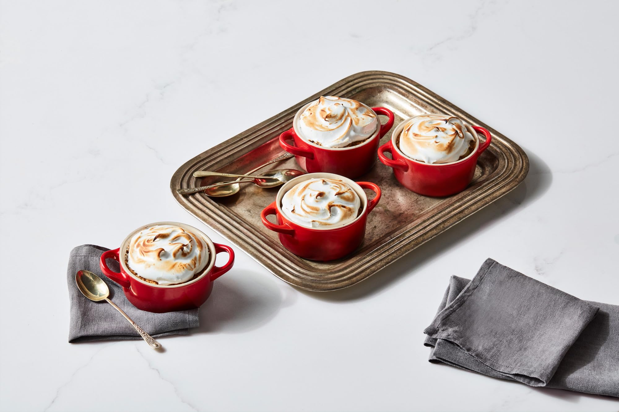 Le Creuset mini round cocotte cerise, versatile for prep, storage, and decorative kitchen color.