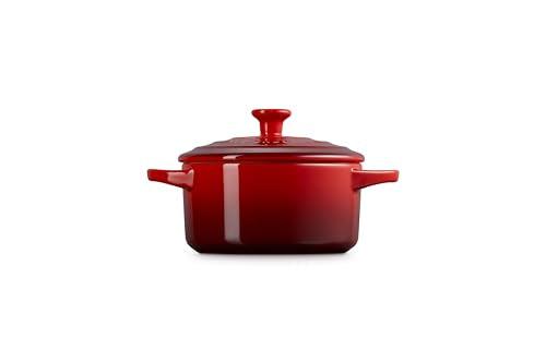 Le Creuset Cerise cocotte serving hot portions at the table.