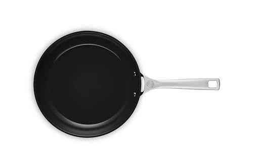 Le Creuset pan handle close-up shows stay-cool grip and durable construction.