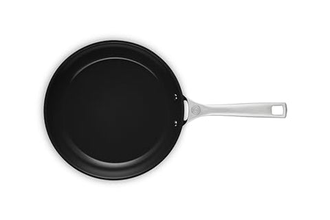 Le Creuset pan handle close-up shows stay-cool grip and durable construction.
