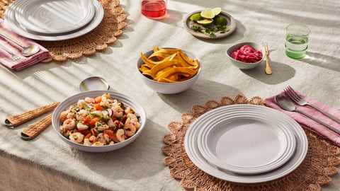 Le Creuset cerise bowls pair with cookware for gatherings and family meals.