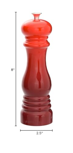 Le Creuset Cerise pepper mill shown on table as a stylish tabletop display