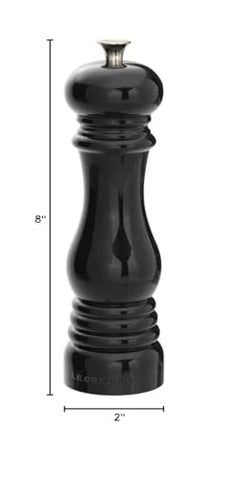 Le Creuset pepper mill dispensing ground pepper, showcasing smooth operation.