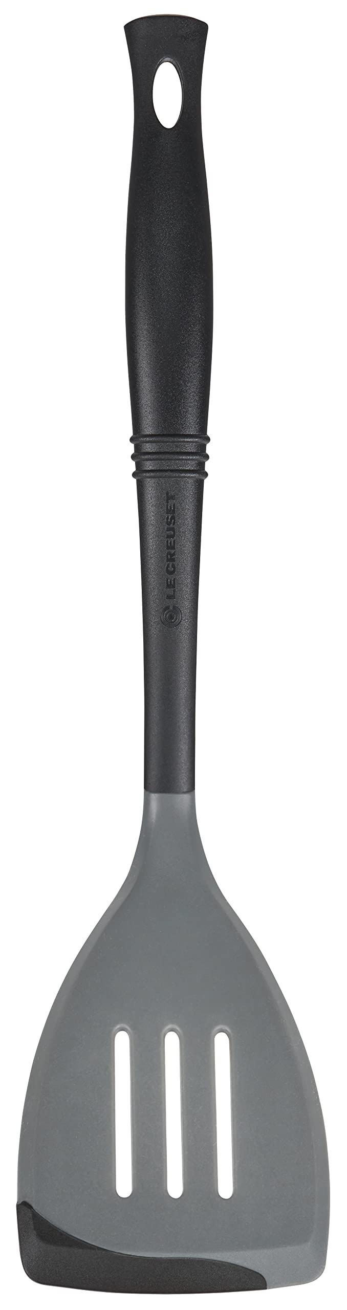 Le Creuset Revolution spatula with oyster finish shows flexible silicone edge for precise flipping.