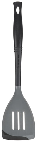Le Creuset Revolution spatula with oyster finish shows flexible silicone edge for precise flipping.