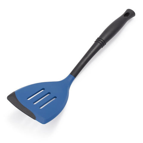 Le Creuset Revolution slotted spatula with elliptical handle for precise control while cooking.