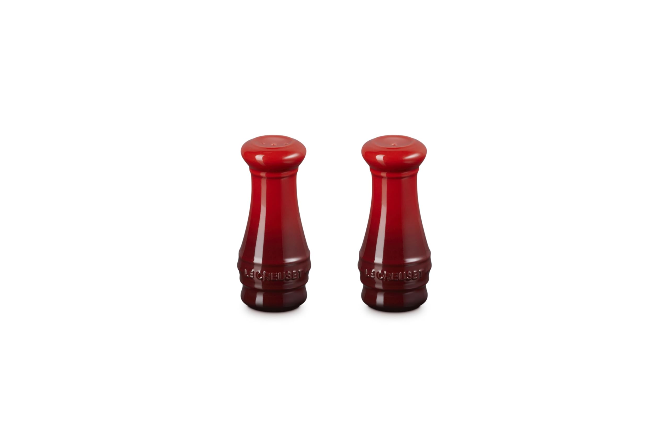 Le Creuset salt and pepper shakers in Cerise on a table for everyday seasoning