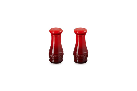 Le Creuset salt and pepper shakers in Cerise on a table for everyday seasoning