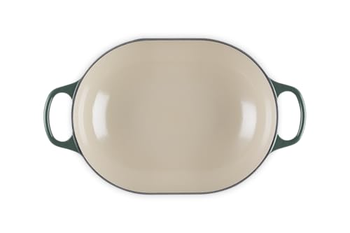 The Le Creuset Signature Oval exterior in Artichaut emphasizes durable enamel and ergonomic handles.