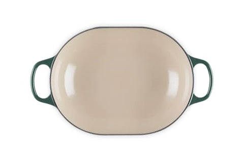 The Le Creuset Signature Oval exterior in Artichaut emphasizes durable enamel and ergonomic handles.